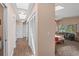 Hallway leading to the main bedroom, showcasing wood-look tile flooring and neutral walls at 5203 Pineview Way, Apopka, FL 32703