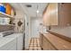 Functional laundry room featuring a sink, storage cabinets, and washer/dryer hookups at 5203 Pineview Way, Apopka, FL 32703
