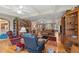Expansive living room with a cozy brick fireplace, hardwood floors, and comfortable seating arrangements at 5203 Pineview Way, Apopka, FL 32703