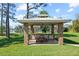 Outdoor kitchen with seating area and brick grill, perfect for outdoor entertaining, with view of the lake at 5203 Pineview Way, Apopka, FL 32703