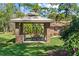 Outdoor kitchen with a built-in grill and a dining table, surrounded by lush landscaping offering a serene atmosphere at 5203 Pineview Way, Apopka, FL 32703