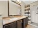 Bathroom showcasing double sinks, stone countertops, and a walk-in shower at 5715 Satel Dr, Orlando, FL 32810
