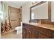 Updated bathroom with tiled shower, large mirror, and dark wood vanity with stone countertop at 5715 Satel Dr, Orlando, FL 32810