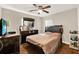 Bedroom featuring hardwood floors, ceiling fan, and a large dresser with mirror at 5715 Satel Dr, Orlando, FL 32810