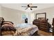Bright bedroom features wood floors, ceiling fan, and a large wooden dresser at 5715 Satel Dr, Orlando, FL 32810