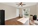 Bright bedroom with wood floors, ceiling fan, and sliding glass door to the backyard at 5715 Satel Dr, Orlando, FL 32810