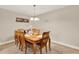 Dining room features tile flooring, chandelier lighting, and a wooden dining set at 5715 Satel Dr, Orlando, FL 32810
