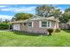 View of the home's exterior with a lush lawn and attached garage at 5715 Satel Dr, Orlando, FL 32810