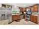 Modern kitchen with stainless steel appliances, granite counters, and ample cabinet space at 5715 Satel Dr, Orlando, FL 32810