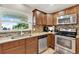 Well-lit kitchen features granite countertops, stainless steel appliances, and a view of the outside at 5715 Satel Dr, Orlando, FL 32810
