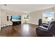 Bright living room with hardwood floors and a comfortable leather recliner at 5715 Satel Dr, Orlando, FL 32810