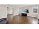 Cozy living area with hardwood flooring, a large TV, and a comfortable recliner at 5715 Satel Dr, Orlando, FL 32810