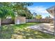 A utility shed sits in the corner of the yard and next to a concrete patio at 5715 Satel Dr, Orlando, FL 32810