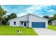 Charming single-story home with blue accents and a well-maintained lawn, creating a welcoming curb appeal at 656 Marion Oaks Mnr, Ocala, FL 34473