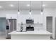Modern kitchen featuring white cabinetry, stainless steel appliances, and a large center island at 656 Marion Oaks Mnr, Ocala, FL 34473