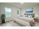 Serene main bedroom with neutral tones, two windows and stylish decor for a relaxing retreat at 656 Marion Oaks Mnr, Ocala, FL 34473