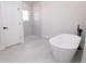 Elegant bathroom featuring a modern tub and a sleek, glass-enclosed shower space at 656 Marion Oaks Mnr, Ocala, FL 34473