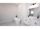 Elegant bathroom with a modern tub, dual vanities with white cabinets, and stylish black fixtures at 656 Marion Oaks Mnr, Ocala, FL 34473