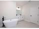 Elegant bathroom with a modern tub, dual vanities with white cabinets, and stylish black fixtures at 656 Marion Oaks Mnr, Ocala, FL 34473