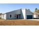 Attractive single-Gathering home showcasing a blue garage door, contemporary architecture, and tidy landscaping at 656 Marion Oaks Mnr, Ocala, FL 34473