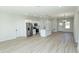 Bright, open kitchen with stainless steel appliances, a center island, and sleek white cabinets at 656 Marion Oaks Mnr, Ocala, FL 34473