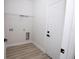This laundry room features sleek wood-look flooring and convenient shelving for organized storage at 656 Marion Oaks Mnr, Ocala, FL 34473