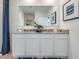 Bathroom featuring a double vanity, a large mirror, and modern decor and finishes at 7077 Painted Bunting Way, St Cloud, FL 34773