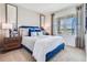 Cozy bedroom with soft carpet, neutral-toned bedding and a window offering outdoor views and ample natural light at 7077 Painted Bunting Way, St Cloud, FL 34773