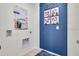 Functional laundry room with artwork creating a unique and stylish space for completing household chores at 7077 Painted Bunting Way, St Cloud, FL 34773