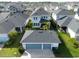 Drone view shows house with a two-car garage, fenced yard, and neighboring homes in a suburban setting at 8852 Sperry St, Orlando, FL 32827