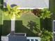 Aerial backyard shot showcasing a landscaped lawn, palm trees, and well-maintained garden beds at 8852 Sperry St, Orlando, FL 32827