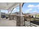 Charming balcony featuring stone pillars, a ceiling fan, and views of the neighborhood street at 8852 Sperry St, Orlando, FL 32827