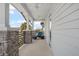 Covered balcony with stone pillars, ceiling fans, a daybed, and views of the neighborhood at 8852 Sperry St, Orlando, FL 32827