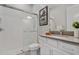 Bathroom with walk-in shower featuring white subway tile and gray vanity at 8852 Sperry St, Orlando, FL 32827