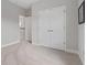 Bright bedroom features neutral carpet, walls, and white doors, offering a calming and clean space at 8852 Sperry St, Orlando, FL 32827