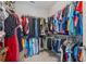 Walk-in closet with ample hanging space and various clothing organized on shelves and racks at 8852 Sperry St, Orlando, FL 32827