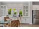 Bright dining area with hardwood floors, lots of cabinetry, and stainless steel refrigerator at 8852 Sperry St, Orlando, FL 32827