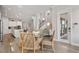 Open dining area is next to stairs, kitchen, and living room with a glass table and hardwood floors at 8852 Sperry St, Orlando, FL 32827