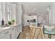 Open dining area with hardwood floors, lots of cabinetry, and stainless steel appliances in view at 8852 Sperry St, Orlando, FL 32827