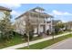 Two-story home with a balcony, stone accents, and landscaped yard, showcasing attractive architectural design at 8852 Sperry St, Orlando, FL 32827