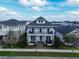 Elegant home with second-story balcony and symmetrical design, complemented by lush greenery and a vibrant blue sky at 8852 Sperry St, Orlando, FL 32827