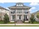 Two-story home featuring stone accents, double porches, and a well-manicured lawn at 8852 Sperry St, Orlando, FL 32827