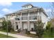 Stylish two-story home with balconies, stone pillars, and landscaped yard, highlighting upscale curb appeal at 8852 Sperry St, Orlando, FL 32827