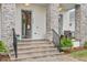 Inviting front porch with stone pillars and seating area, offering a welcoming entryway to the home at 8852 Sperry St, Orlando, FL 32827