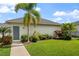 Charming house exterior with landscaped front yard, walkway, and inviting entrance, showcasing curb appeal at 8852 Sperry St, Orlando, FL 32827