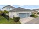 Two-car garage with a well-kept exterior and driveway, complemented by adjacent landscaping and a fence at 8852 Sperry St, Orlando, FL 32827