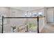 Second story hallway with a view of the entry way, abundant light, and wood and white banister at 8852 Sperry St, Orlando, FL 32827