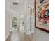Hallway with wood floors leads to the home's various living spaces and abundant natural light at 8852 Sperry St, Orlando, FL 32827
