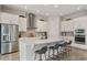 Bright kitchen features white cabinets, stainless steel appliances, and a spacious island with bar seating at 8852 Sperry St, Orlando, FL 32827