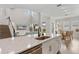 Open concept: Spacious kitchen island flows into living and dining areas with hardwood floors and natural light at 8852 Sperry St, Orlando, FL 32827